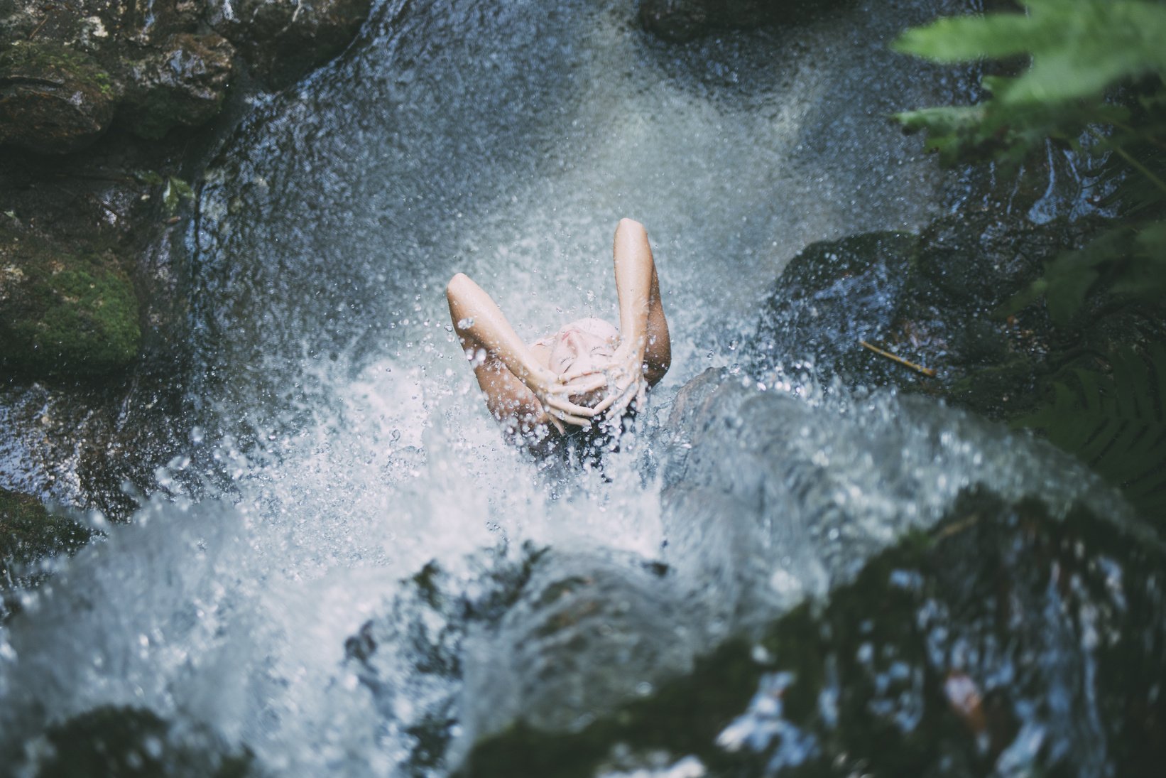 A Woman Showering at the Waterfall